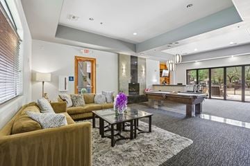Phoenix apartment for rent - A living room with a brown couch and a pool table.