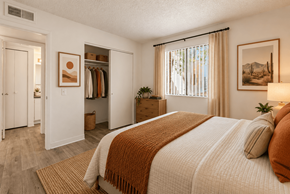 Tucson apartment for rent - A bedroom with a large bed and a wardrobe.
