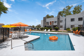 Tucson apartment for rent - A pool with a sun lounger and umbrella.