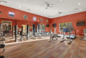 Goodyear apartment for rent - A gym with a variety of equipment including treadmills, weights, and exercise machines.