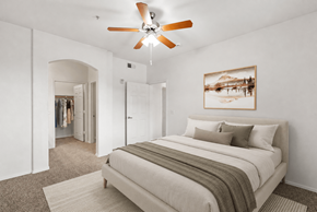 Goodyear apartment for rent - A bedroom with a large bed and a ceiling fan.