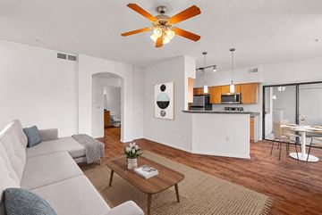 Goodyear apartment for rent - A living room with a grey couch and a wooden coffee table.