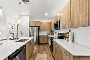 Marana apartment for rent - A modern kitchen with wooden cabinets and stainless steel appliances.