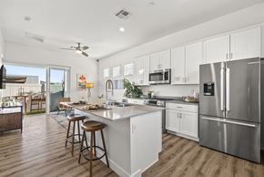 Goodyear apartment for rent - A modern kitchen with white cabinets and stainless steel appliances.