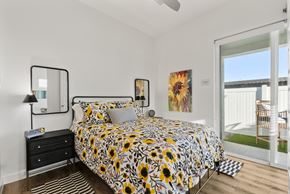Goodyear apartment for rent - A bedroom with a bed, nightstand, and a painting on the wall.