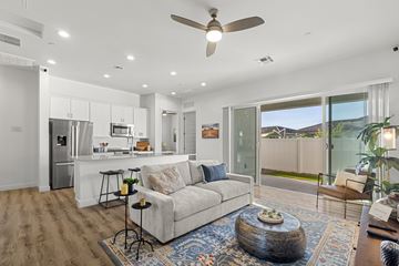 Goodyear apartment for rent - A modern living room with a white sofa and a glass table.