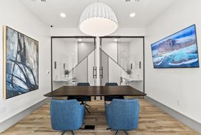 Mesa apartment for rent - A modern dining room with a wooden table and blue chairs.