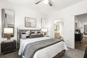 Mesa apartment for rent - A bedroom with a large bed and a ceiling fan.