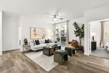 Mesa apartment for rent - A living room with a white couch, a coffee table, and a painting on the wall.