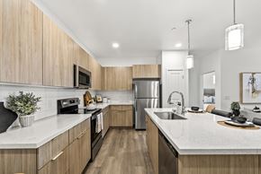 Mesa apartment for rent - A modern kitchen with wooden cabinets and stainless steel appliances.