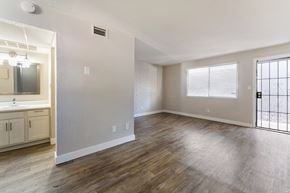 Tucson apartment for rent - Bathroom Vanity and living room at Avani North Tucson Apartments in Tucson Arizona