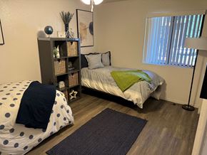 Flagstaff apartment for rent - a bedroom with a bed and a nightstand and a window