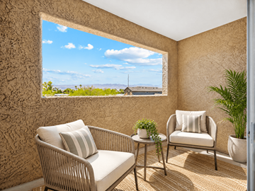 Bullhead City apartment for rent - A patio with a chair and a table with a view of the mountains.