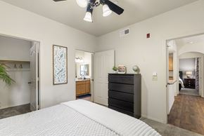 Surprise apartment for rent - A bedroom with a large bed and a ceiling fan.