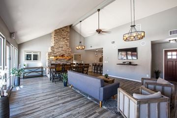 Tucson townhouse for rent - the living room of a house with a couch and a table and chairs