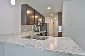Columbia apartment for rent - A kitchen with a marble countertop and a modern design.