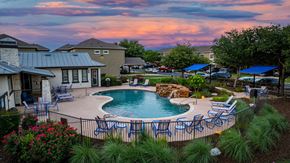 Round Rock apartment for rent - A backyard with a pool and patio furniture.