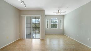 Tampa apartment for rent - A spacious room with a sliding glass door leading to a balcony.