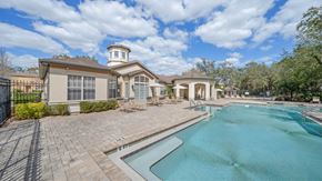 Tampa apartment for rent - A large house with a pool in front.