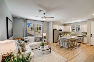 Gilbert apartment for rent - A modern living room with a white couch and a coffee table.