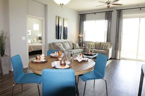Tucson apartment for rent - A dining room with a round table and blue chairs.