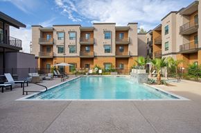Scottsdale apartment for rent - A large swimming pool in front of apartment buildings.