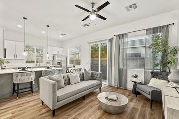 Goodyear apartment for rent - A modern living room with a grey sofa and a wooden coffee table.