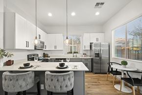 Goodyear apartment for rent - A modern kitchen with a dining table and chairs.