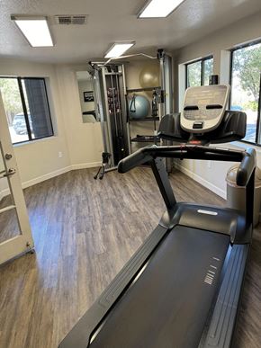 Flagstaff apartment for rent - a gym with a treadmill and a chair in it
