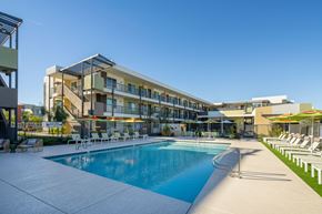 Glendale apartment for rent - A swimming pool is surrounded by sun loungers and umbrellas.