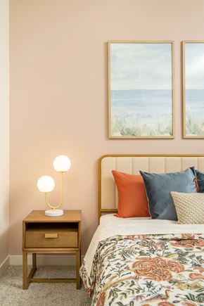 Glendale apartment for rent - A bedroom with a bed, a nightstand with a lamp, and two pictures on the wall.