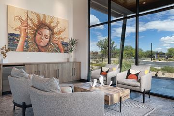Tucson apartment for rent - A living room with a large painting of a woman with sun in her hair.