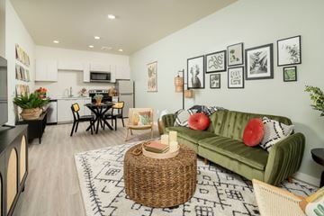 Phoenix apartment for rent - a living room with a green couch and a table and a kitchen