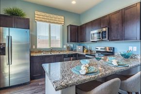 Tucson apartment for rent - A kitchen with a granite countertop and a refrigerator.
