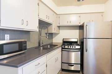 Phoenix apartment for rent - a kitchen with stainless steel appliances and white cabinets