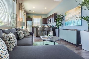 Tucson apartment for rent - A modern living room with a grey sofa and a coffee table.