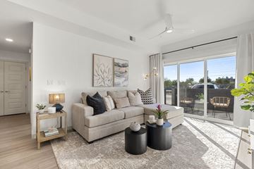 Phoenix apartment for rent - A living room with a couch, a table, and a painting on the wall.