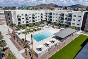 Phoenix apartment for rent - A large white apartment complex with a pool in the middle.