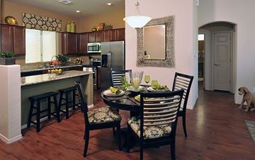 Tucson apartment for rent - A kitchen with a table and chairs and a dog.