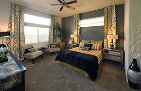 Tucson apartment for rent - A bedroom with a large bed and a ceiling fan.