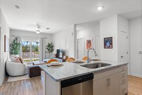 Ft. Myers apartment for rent - A modern kitchen with a dining table and chairs.