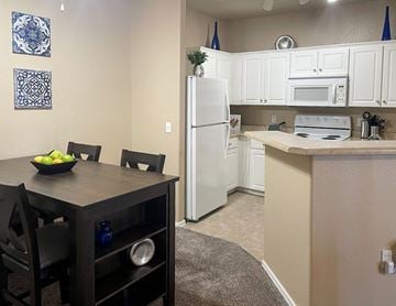 Avondale apartment for rent - A kitchen with a table and chairs and a bowl of fruit on it.