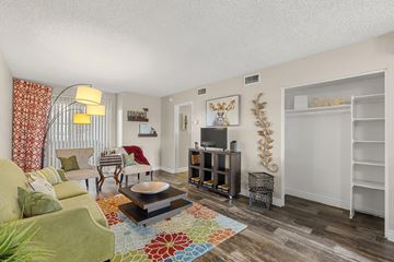 Phoenix apartment for rent - A living room with a green couch and a coffee table.