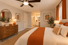 Tucson townhouse for rent - A bedroom with a large bed and a ceiling fan.