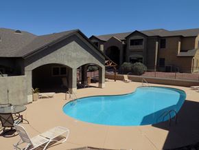 Bullhead City apartment for rent - A swimming pool in a backyard with a patio and a house in the background.
