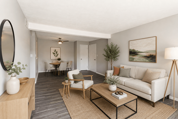 Lexington apartment for rent - A living room with a white couch, a coffee table, and a painting on the wall.