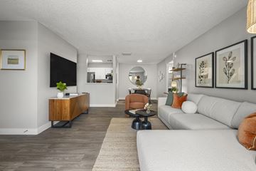 Tucson apartment for rent - A living room with a white couch and a wooden side table.