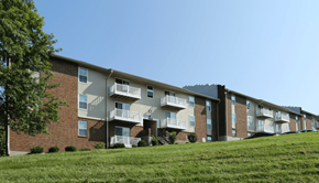 Lexington apartment for rent - Apartment building with balconies and a green lawn in front.