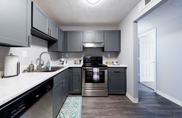 Lexington apartment for rent - A kitchen with a black dishwasher and a black oven.