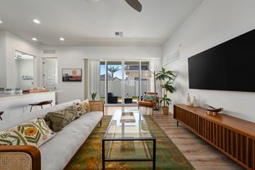 Surprise apartment for rent - A living room with a white couch and a glass coffee table.